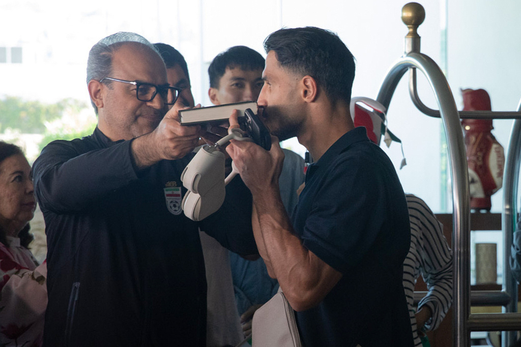 A member of the Iran national soccer team kisses the Quran as he departs from the Tijuana Marriott in Tijuana, Mexico on Saturday June 20, 2026. (AP Photo/Gabriela Aoun Angueira)