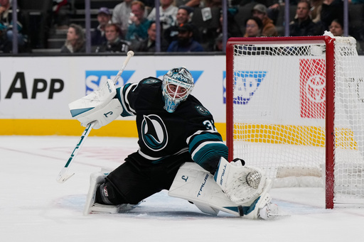 San Jose Sharks goaltender Alex Nedeljkovic deflects a shot during the second period of an NHL hockey game against the Carolina Hurricanes, Tuesday, Oct. 14, 2025, in San Jose, Calif. (AP Photo/Godofredo A. Vásquez) San Jose Sharks goaltender Alex Nedeljkovic deflects a shot during the second period of an NHL hockey game against the Carolina Hurricanes, Tuesday, Oct. 14, 2025, in San Jose, Calif. (AP Photo/Godofredo A. Vásquez)