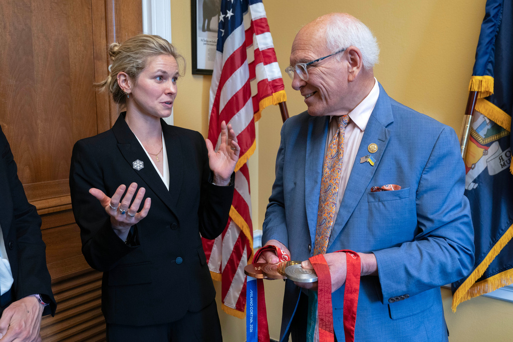 Rep. Paul Tonko, D-N.Y., speaks with Olympian Jessie Diggins as she shows him her medals during a meeting to advocate for clean air, clean water and a healthy planet on Capitol Hill Tuesday, June 23, 2026, in Washington. (AP Photo/Jose Luis Magana)