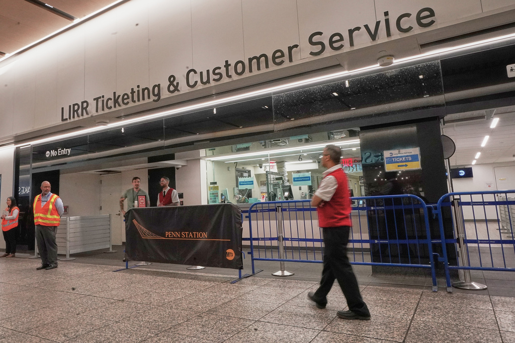 Workers stand near the Long Island Raill Road ticketing counter in New York's Penn Station, Tuesday, May 19, 2026. (AP Photo/Richard Drew)