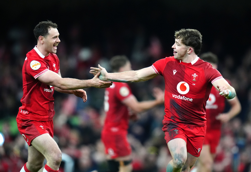 Wales' Daniel Edwards celebrates scoring a drop goal with team-mate Tomos Williams during the Men's Six Nations match between Wales and Italy in Cardiff, Wales, Saturday March 14, 2026. (David Davies/PA via AP)