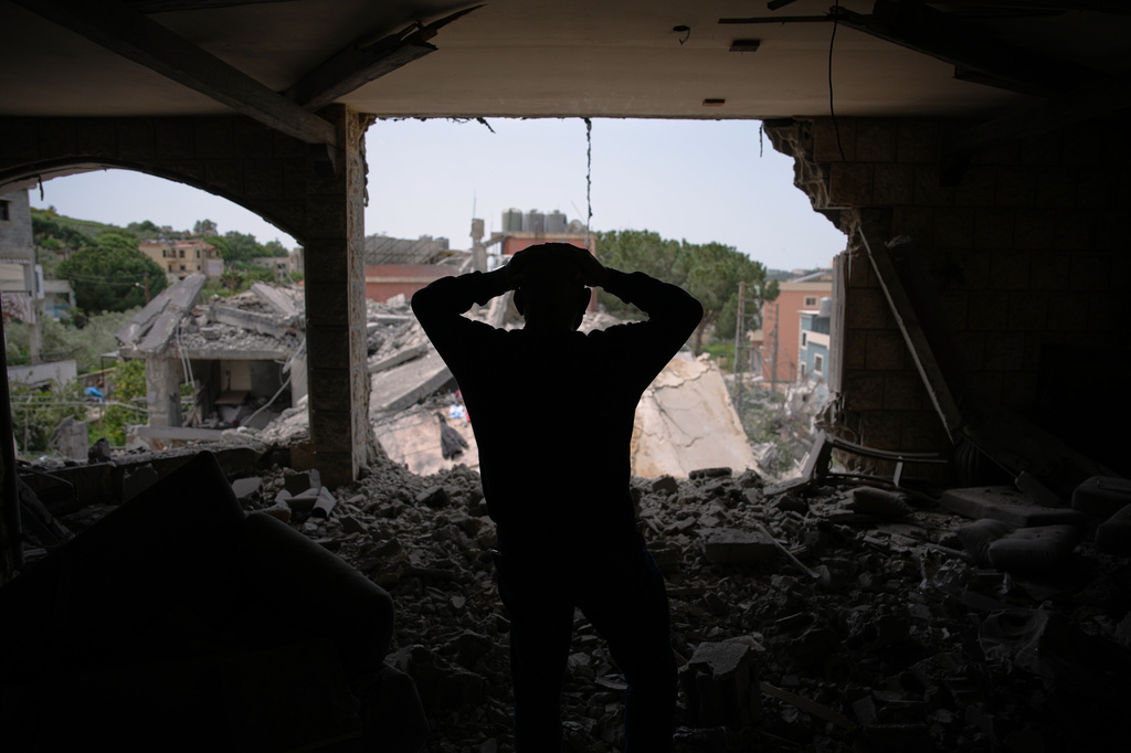 Assem Abdallah reacts as he enters his friend apartment destroyed in a Israeli airstrike in Kfar Roumman, southern Lebanon, Friday, April 17, 2026, following a ceasefire between Israel and Hezbollah. (AP Photo/Hassan Ammar)