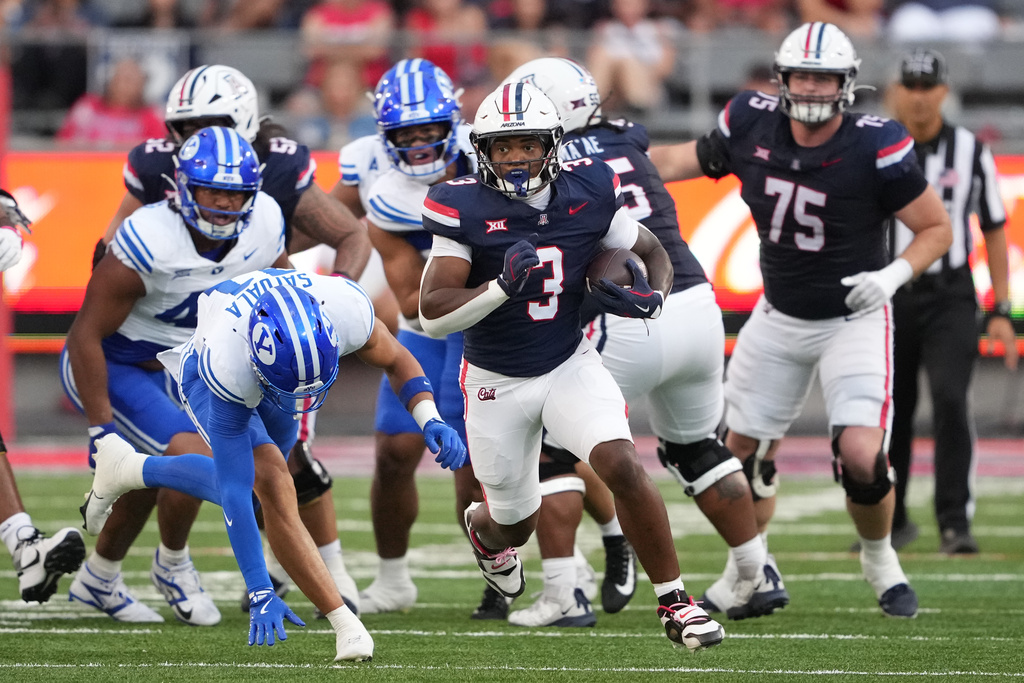 Arizona running back Kedrick Reescano runs the ball against BYU in the first half of an NCAA college football game Saturday, Oct. 11, 2025, in Tucson, Ariz. (AP Photo/Rick Scuteri)