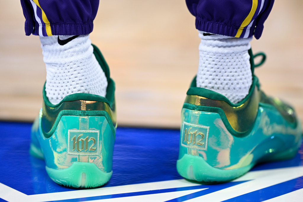 Los Angeles Lakers forward LeBron James wears shoes commemorating his record-breaking game before an NBA basketball game against the Orlando Magic, Saturday, March 21, 2026, in Orlando, Fla. (AP Photo/Phelan M. Ebenhack)