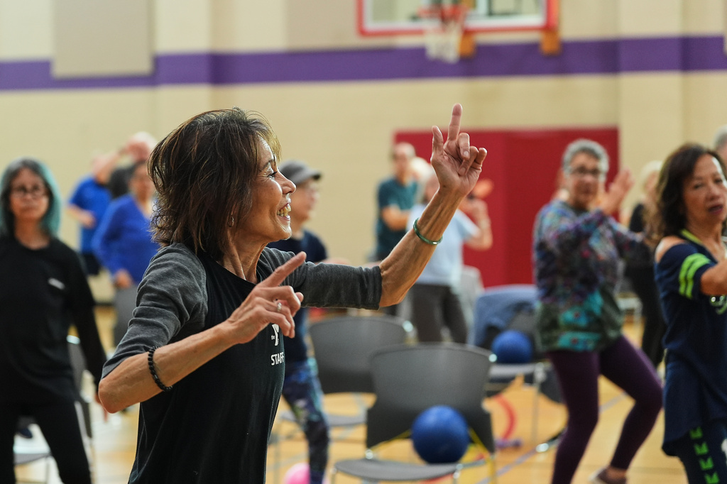 Instructor Bengie Santos, 72, leads a class for older adults at the Dale Turner Family YMCA, April 30, 2026, in Shoreline, Wash. (AP Photo/Lindsey Wasson)