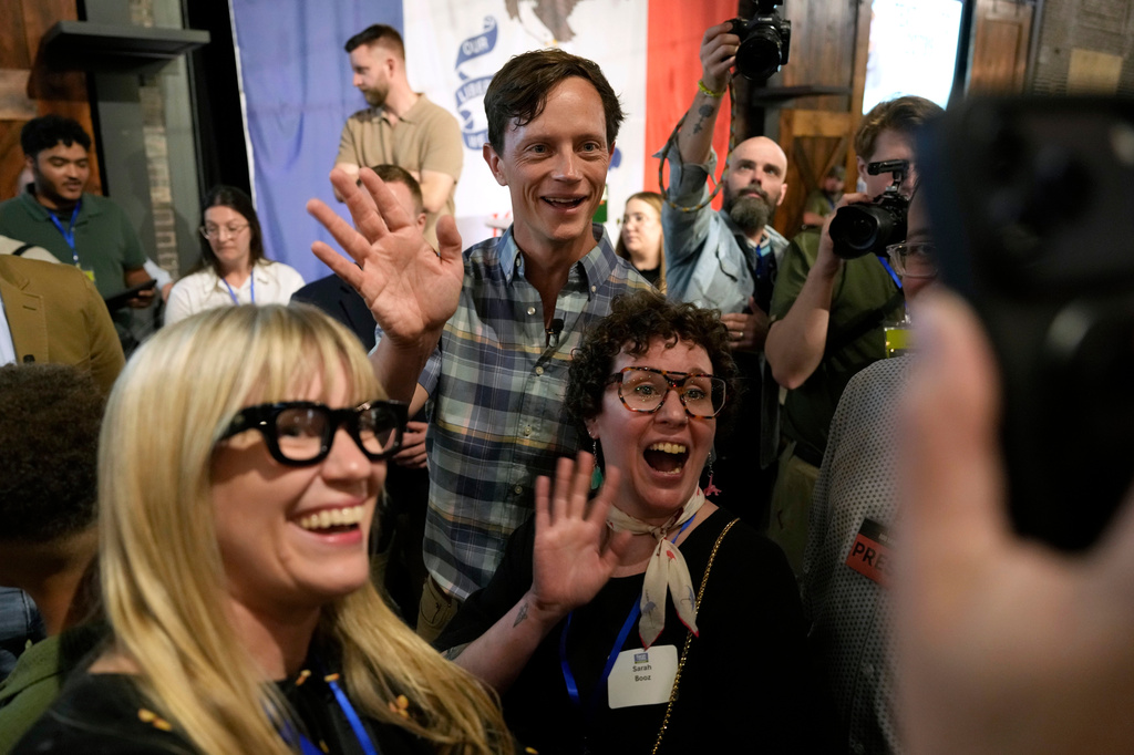 Iowa Democratic gubernatorial candidate Rob Sand poses for a photo with supporters during a campaign rally, Sunday, June 7, 2026, in Des Moines, Iowa. (AP Photo/Charlie Neibergall)