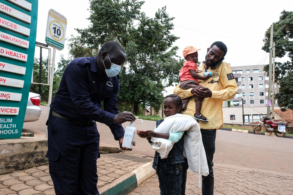A girl sanitises her hands in front of Kibuli Muslim Hospital in Kampala, Uganda, Saturday, May 16, 2026. (AP Photo/ Hajarah Nalwadda)