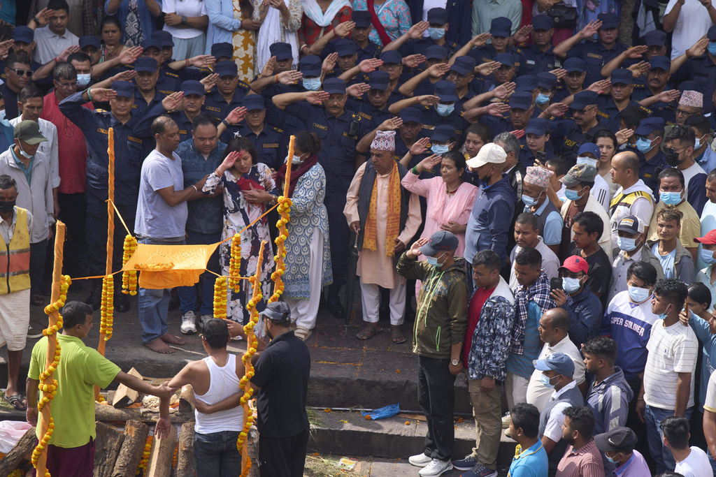 Mourners pay their last respects to Assistant Sub-Inspector officer Milan Raya, who was killed during anti-corruption protests that erupted after a social media ban was later revoked is prepared for cremation at Pashupatinath in Kathmandu, Nepal, Friday, Sept. 12, 2025. (AP Photo/Niranjan Shrestha)