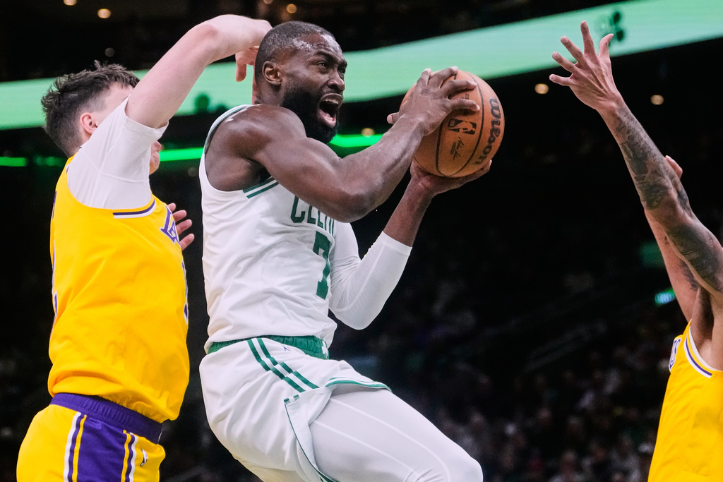 Boston Celtics guard Jaylen Brown (7) drives to the basket against the Los Angeles Lakers during the first half of an NBA basketball game, Friday, Dec. 5, 2025, in Boston. (AP Photo/Charles Krupa)