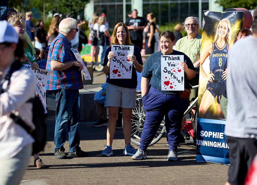 People rally to support Indiana Fever guard Sophie Cunningham after her comments on transgender athletes in women's sports before a WNBA basketball game between the Portland Fire and the Indiana Fever in Portland, Ore., Friday, July 31, 2026. (AP Photo/Craig Mitchelldyer)