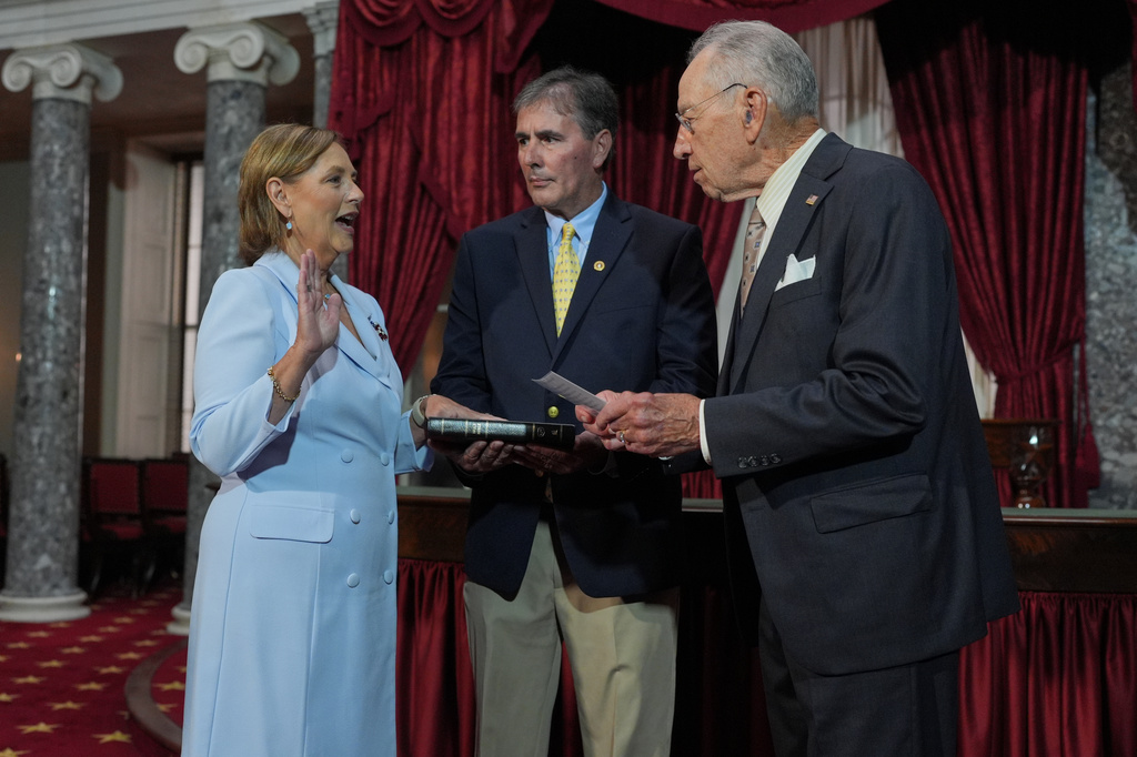 Darline Graham, sister of Sen. Lindsey Graham, R-S.C., is ceremonially sworn-in by President Pro Tempore of the Senate, Chuck Grassley, R-Iowa, in the Old Senate Chamber at the Capitol in Washington, Tuesday, July 14, 2026, as her husband Larry Nordone holds the Bible. (AP Photo/J. Scott Applewhite)