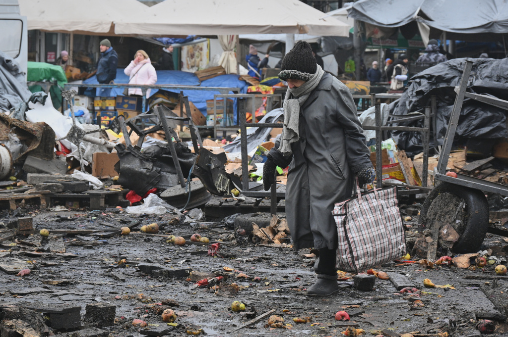 People walk at a ruined city market following a Russia's attack in Odesa, Ukraine, Thursday, Feb. 12, 2026. (AP Photo/Michael Shtekel)