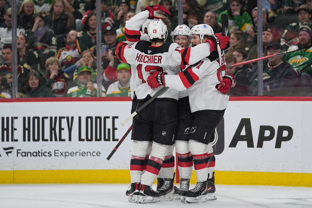 New Jersey Devils left wing Ondrej Palat (18) celebrates with teammates after scoring during the second period of an NHL hockey game against the Minnesota Wild, Monday, Jan. 12, 2026, in St. Paul, Minn. (AP Photo/Abbie Parr)