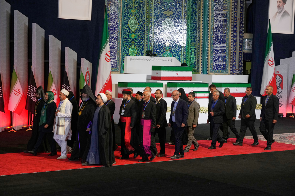 Iranian religious leaders and other mourners walk past the coffins of slain Iranian Supreme Leader Ayatollah Ali Khamenei and members of his family during a viewing ceremony ahead of the dayslong funeral ceremonies at the Imam Khomeini Mosalla Grand Mosque in Tehran, Iran, Friday, July 3, 2026. (AP Photo/Vahid Salemi) The religious leaders are Iranian, not foreigners