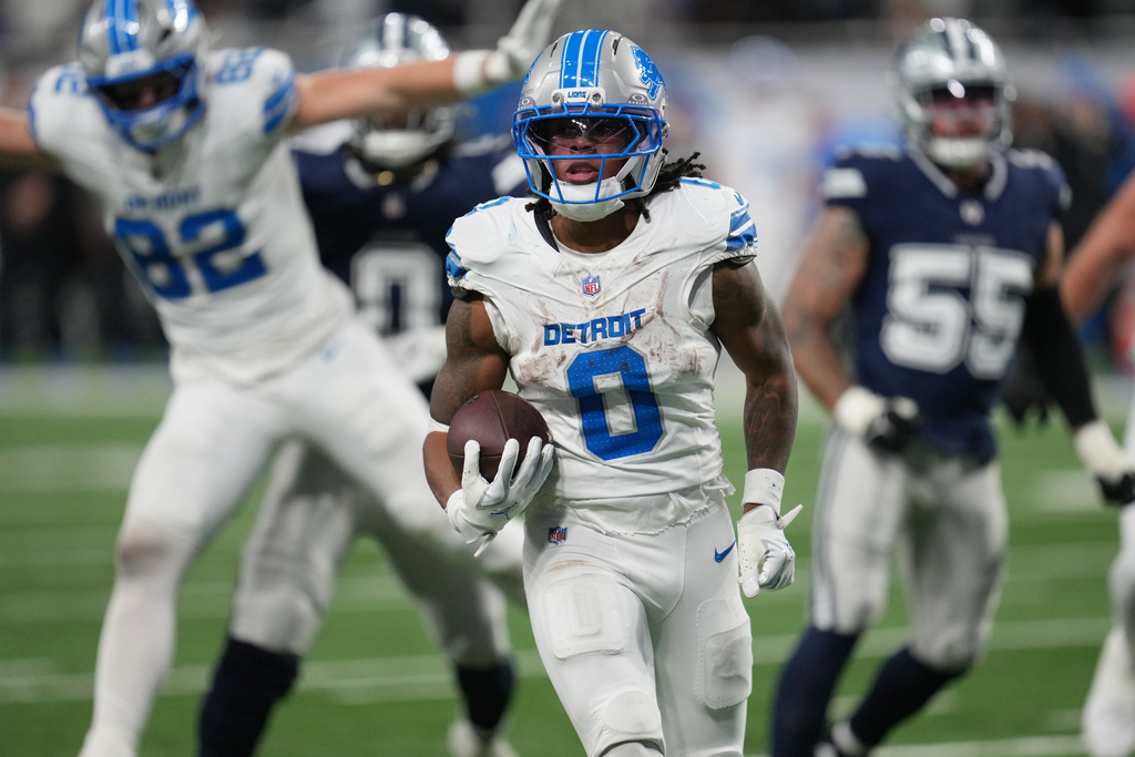 Detroit Lions running back Jahmyr Gibbs (0) runs for a touchdown against the Dallas Cowboys during the second half of an NFL football game Thursday, Dec. 4, 2025, in Detroit. (AP Photo/Paul Sancya)