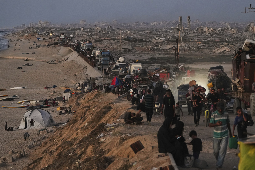 Displaced Palestinians flee northern Gaza along the coastal road toward the south, as Israel announced an expanded operation in Gaza City, Tuesday, Sept. 16, 2025. (AP Photo/Abdel Kareem Hana)