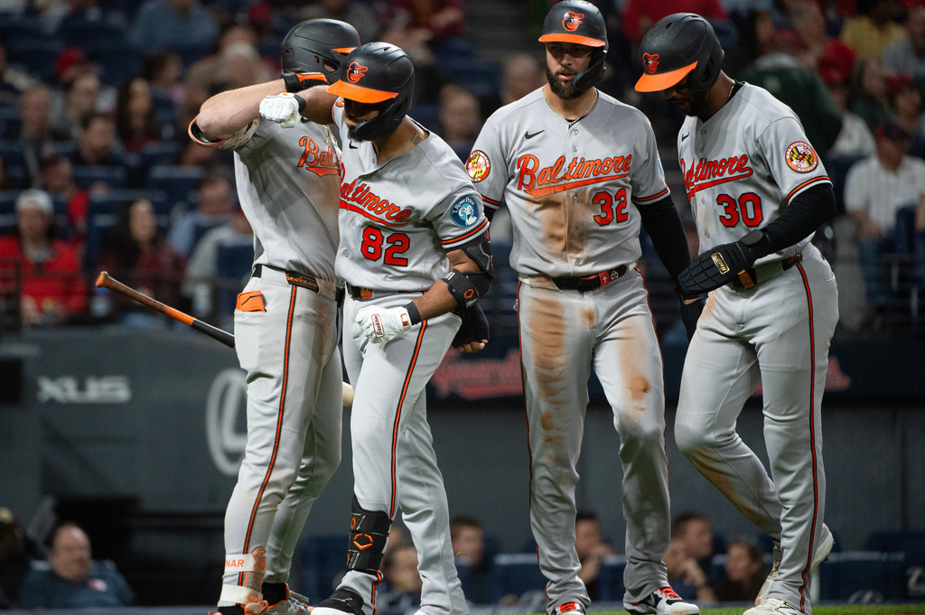 Baltimore Orioles' Jeremiah Jackson (82) is greeted by Colton Cowser, left, Weston Wilson (32) and Leody Taveras (30) after hitting a three-run home run off Cleveland Guardians relief pitcher Connor Brogdon during the eighth inning of a baseball game, Friday, April 17, 2026, in Cleveland. (AP Photo/Phil Long)