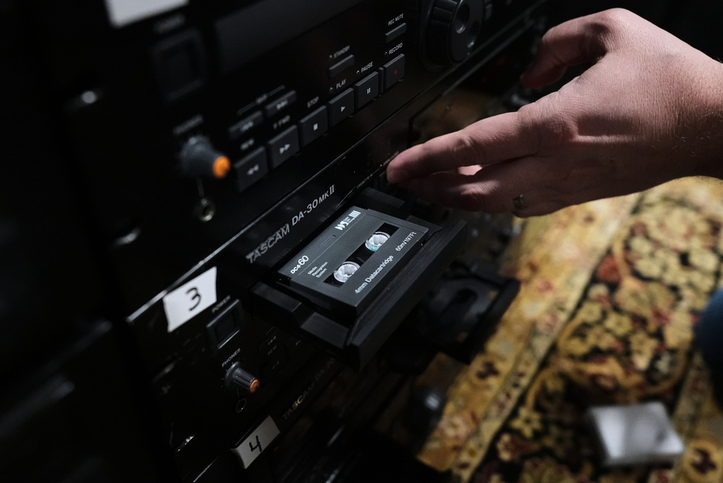 Brian Emerick plays a recorded tape at his home in Des Plaines, Ill., Thursday, March 19, 2026. (AP Photo/Nam Y. Huh)