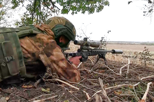 In this photo taken from video distributed by Russian Defense Ministry Press Service on Monday, Oct. 6, 2025, a Russian sniper fires towards Ukrainian forces from an undisclosed location. (Russian Defense Ministry Press Service via AP) In this photo taken from video distributed by Russian Defense Ministry Press Service on Monday, Oct. 6, 2025, a Russian sniper fires towards Ukrainian forces from an undisclosed location. (Russian Defense Ministry Press Service via AP)