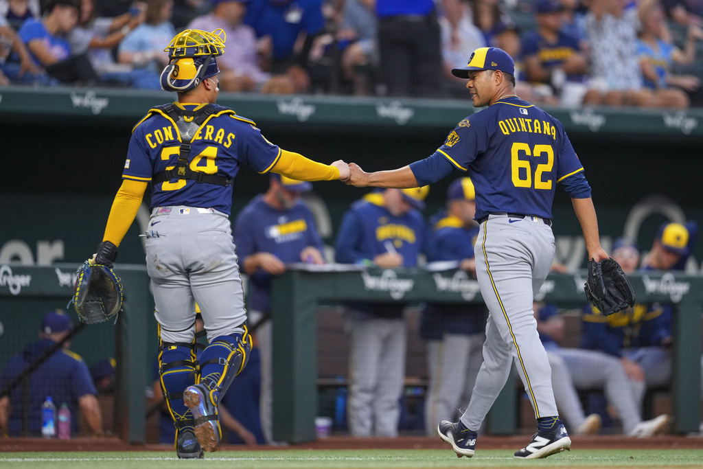 Milwaukee Brewers starting pitcher Jose Quintana (62) and catcher William Contreras (24) react after pitching to the Texas Rangers during the first inning of a baseball game Monday, Sept. 8, 2025, in Arlington, Texas. (AP Photo/Julio Cortez)