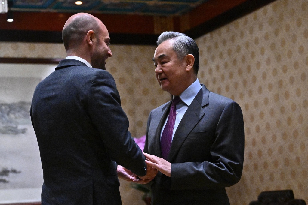 France's Foreign Affairs Minister Jean-Noel Barrot, left, and Chinese Foreign Minister Wang Yi shake hands before their meeting at the Diaoyutai State Guesthouse in Beijing, China, Wednesday, Dec. 3, 2025. (Pedro Pardo/Pool Photo via AP)
