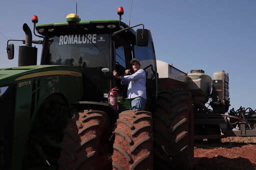 FILE - Farmer Andrey Rodrigues, who chairs the soybean farmers association in Sao Paulo state, talks to a worker operating a tractor pulling a seeder during the planting season on the Morada do Sol farm in Santa Cruz do Rio Pardo, Brazil, Oct. 15, 2025. (AP Photo/Ettore Chiereguini, File) FILE - Farmer Andrey Rodrigues, who chairs the soybean farmers association in Sao Paulo state, talks to a worker operating a tractor pulling a seeder during the planting season on the Morada do Sol farm in Santa Cruz do Rio Pardo, Brazil, Oct. 15, 2025. (AP Photo/Ettore Chiereguini, File)
