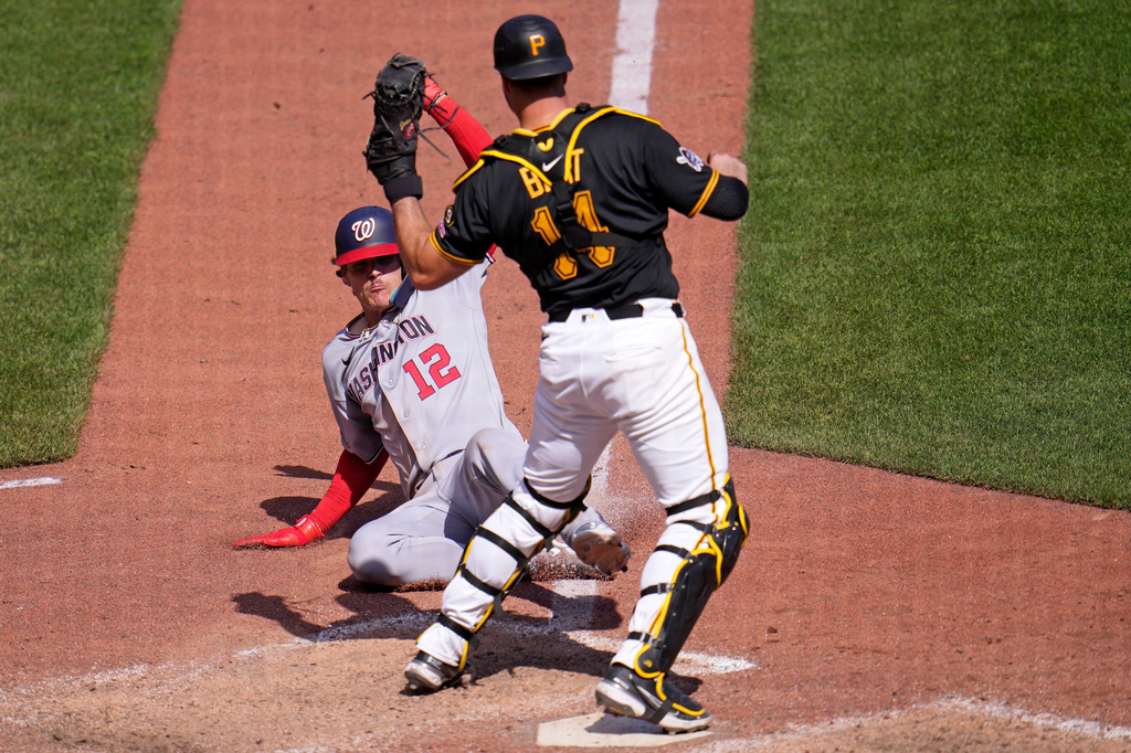 Pittsburgh Pirates catcher Joey Bart gets the force out at home plate on Washington Nationals' Brady House (12) during the ninth inning of a baseball game in Pittsburgh, Thursday, April 16, 2026. (AP Photo/Gene J. Puskar)