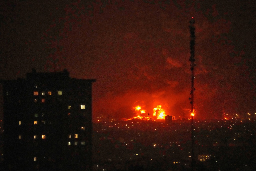 Flames rise from an oil storage facility south of the capital Tehran as strikes hit the city during the U.S.–Israel military campaign, Iran, Saturday, March 7, 2026. (AP Photo/Vahid Salemi)