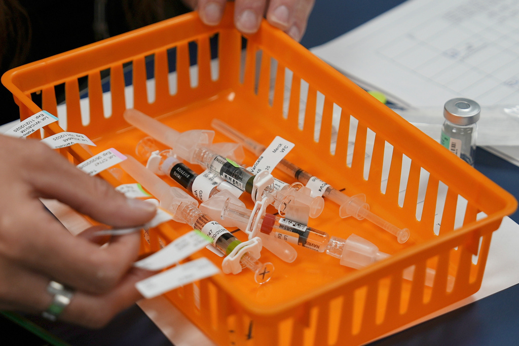 FILE - Vaccines are prepared for students during a pop-up immunization clinic at a school in Louisville, Ky., on Thursday, Aug. 8, 2024. (AP Photo/Mary Conlon, File)