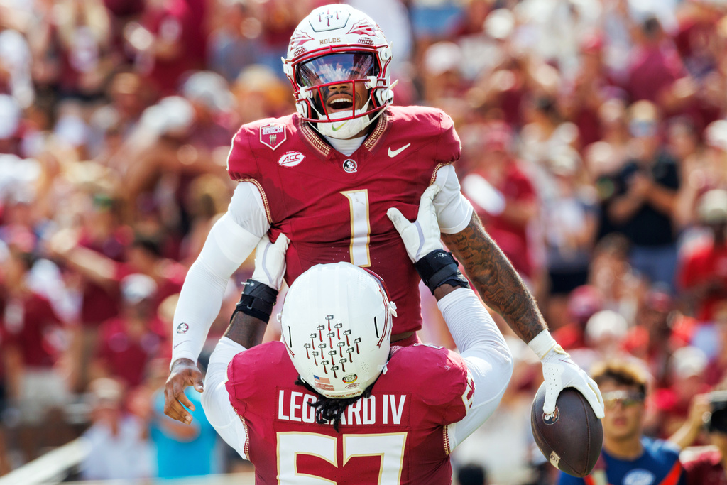 Florida State quarterback Tommy Castellanos (1) celebrates after scoring a touchdown with Florida State offensive lineman Richie Leonard IV (67) during the first half of an NCAA college football game against Kent State, Saturday, Sept. 20, 2025, in Tallahassee, Fla. (AP Photo/Colin Hackley)