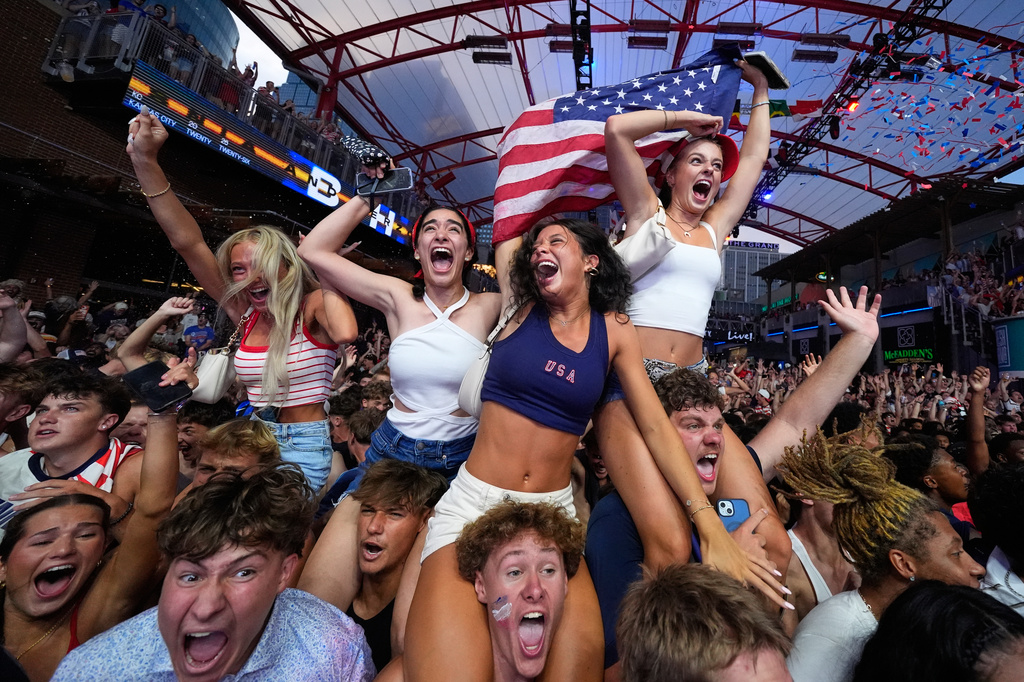 Fans celebrate after a United States goal during a watch party for a World Cup soccer match against Bosnia at the KC Live! entertainment district Wednesday, July 1, 2026, in Kansas City, Mo. (AP Photo/Charlie Riedel)