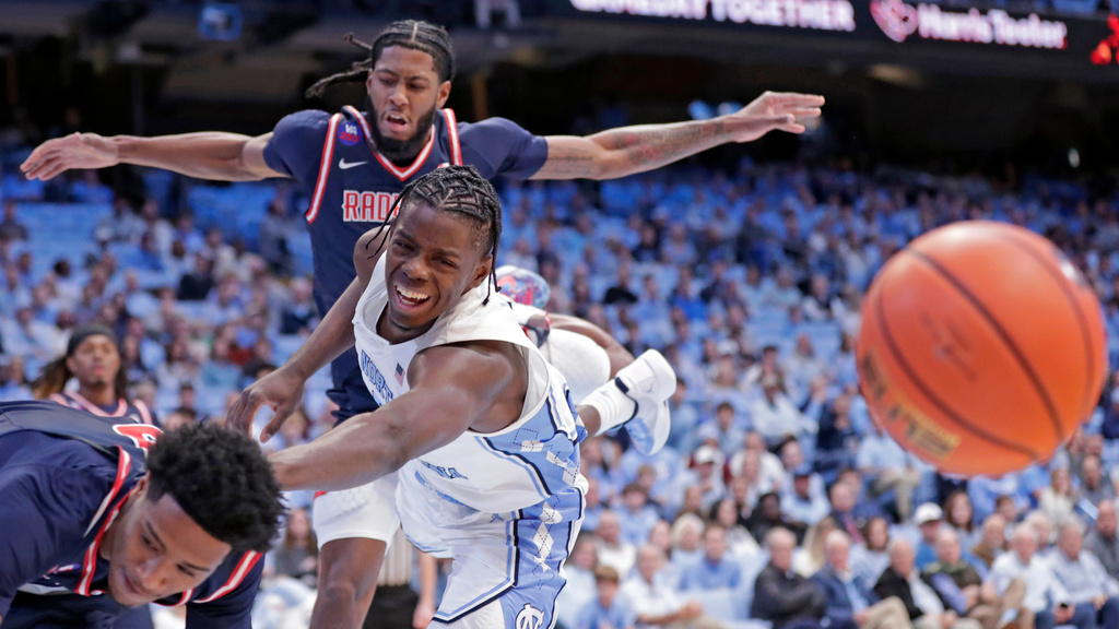 North Carolina forward Caleb Wilson, center, battles Radford guard Del Jones, left, and Radford guard Mari Jordan, back, for the ball during the first half of an NCAA college basketball game Tuesday, Nov. 11, 2025, in Chapel Hill, N.C. (AP Photo/Chris Seward)