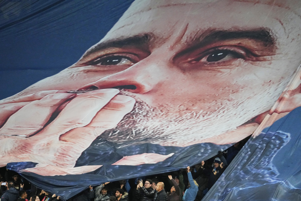 Fans tribute to Pep Guardiola coach of Manchester City 1000th game during the English Premier League soccer match between Manchester City and Liverpool in Manchester, England, Sunday, Nov. 9, 2025. (AP Photo/Jon Super)