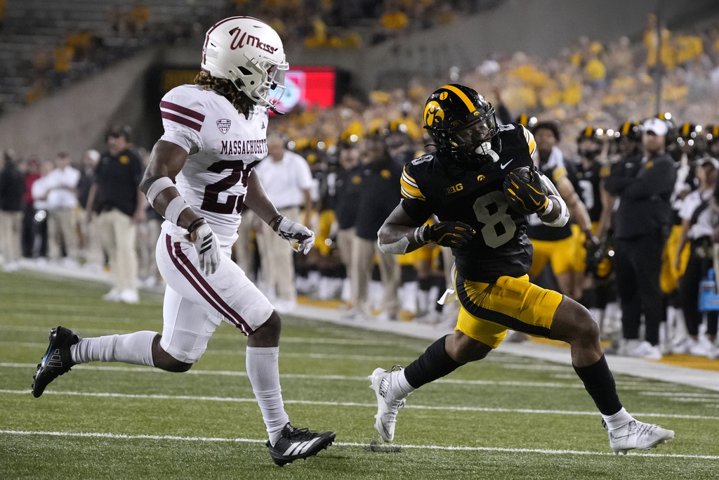 Iowa running back Terrell Washington Jr. (8) runs from Massachusetts defensive lineman Zachary Farris (29) during the second half of an NCAA college football game, Saturday, Sept. 13, 2025, in Iowa City, Iowa. (AP Photo/Charlie Neibergall)