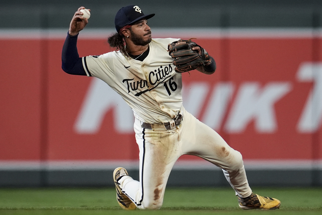 Minnesota Twins outfielder Austin Martin (16) fields a ball hit by New York Yankees' Ryan McMahon in the fourth inning of a baseball game, Tuesday, Sept. 16, 2025, in Minneapolis. (AP Photo/Mike Stewart)