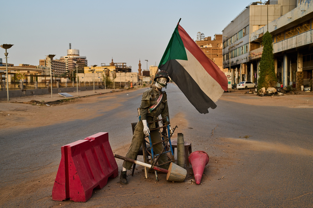 An empty checkpoint where a mannequin dressed as a soldier stands in downtown Khartoum, Sudan, Sunday, April 19, 2026. (AP Photo/Bernat Armangue)