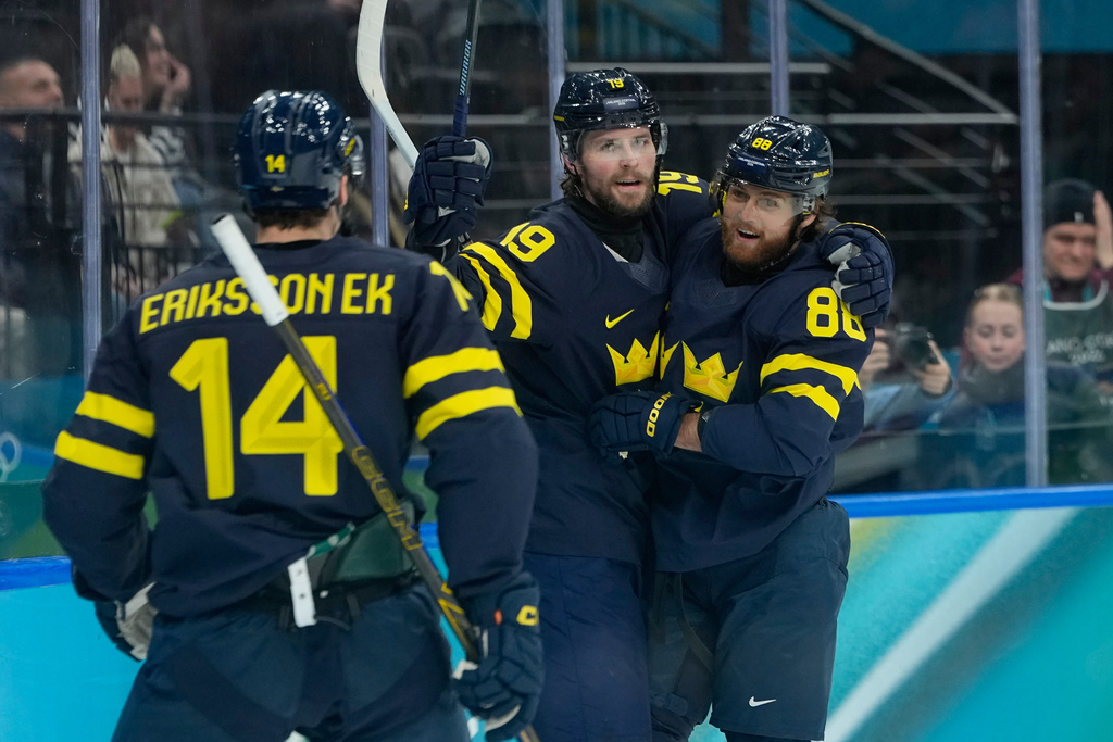 Sweden's Adrian Kempe (19) celebrates after scoring his side's opening goal during a men's ice hockey qualification playoff game between Sweden and Latvia at the 2026 Winter Olympics, in Milan, Italy, Tuesday, Feb. 17, 2026. (AP Photo/Petr David Josek)