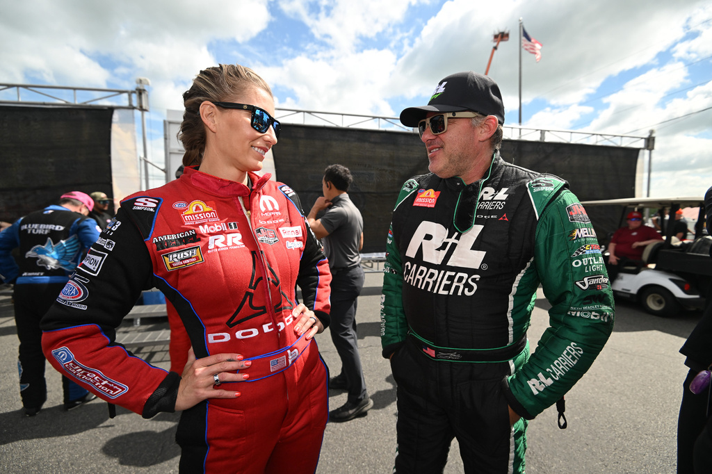 Married NHRA drivers Leah Pruett, left, and Tony Stewart chat pre-race at New England Dragway in Epping, NH, Sunday, June 7, 2026, for the NHRA New England Nationals. (Marc Gewertz/NHRA via AP)