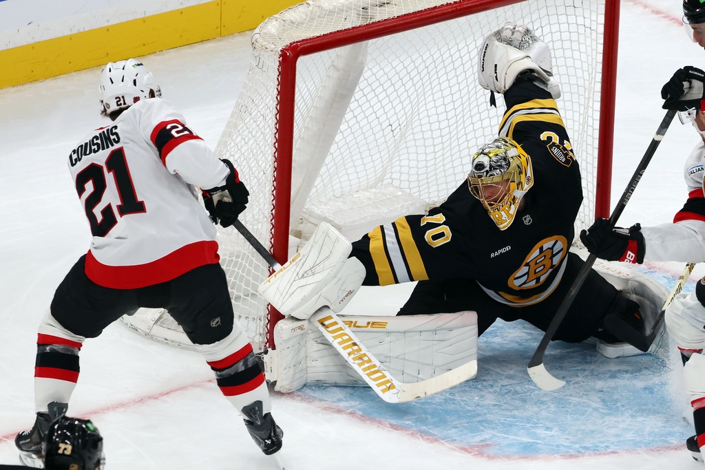 Boston Bruins' Joonas Korpisalo (70) blocks a shot by Ottawa Senators' Nick Cousins (21) during the first period of an NHL hockey game, Thursday, Nov. 6, 2025, in Boston. (AP Photo/Michael Dwyer)