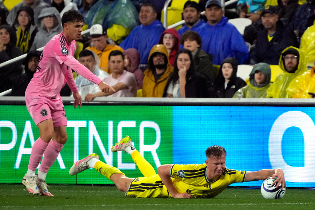 Inter Miami defender Noah Allen, left, protests a play by Nashville SC forward Sam Surridge, right, in the first half of a CONCACAF Champions Cup Round of 16 soccer match Wednesday, March 11, 2026, in Nashville, Tenn. (AP Photo/Mark Humphrey)