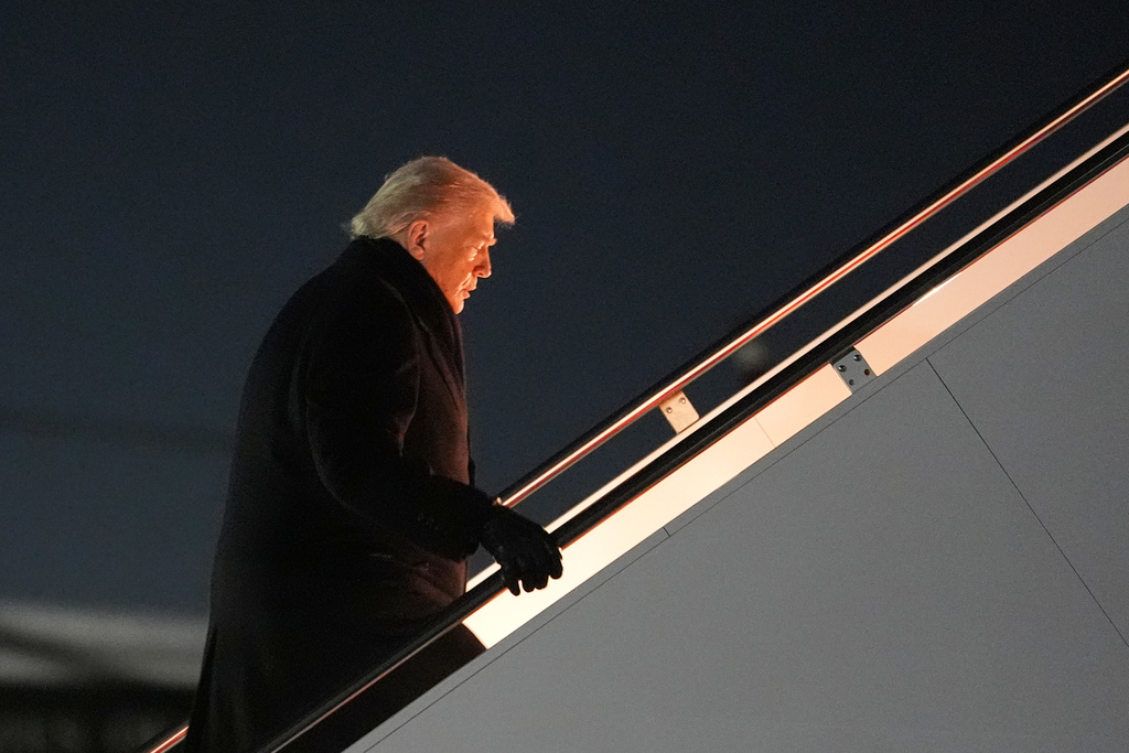 President Donald Trump boards Air Force One for a trip to attend the World Economic Form in Davos, Tuesday, Jan. 20, 2026, at Joint Base Andrews, Md. (AP Photo/Evan Vucci)