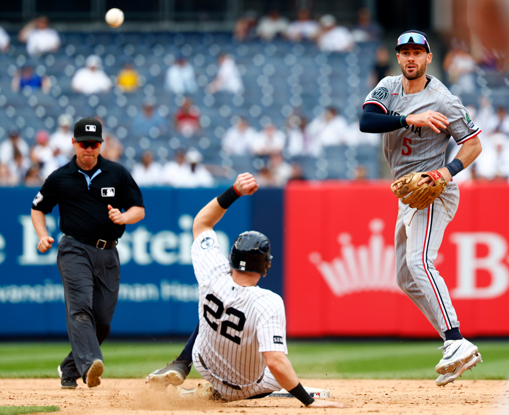 Minnesota Twins' center fielder Ryan Kreidler (5) makes the throw to first base to complete the double play. New York Yankees Ben Rice (22) and Jasson Domínguez were out on the play during the ninth inning of a baseball game, Sunday, July 5, 2026, in New York. (AP Photo/Noah K. Murray)