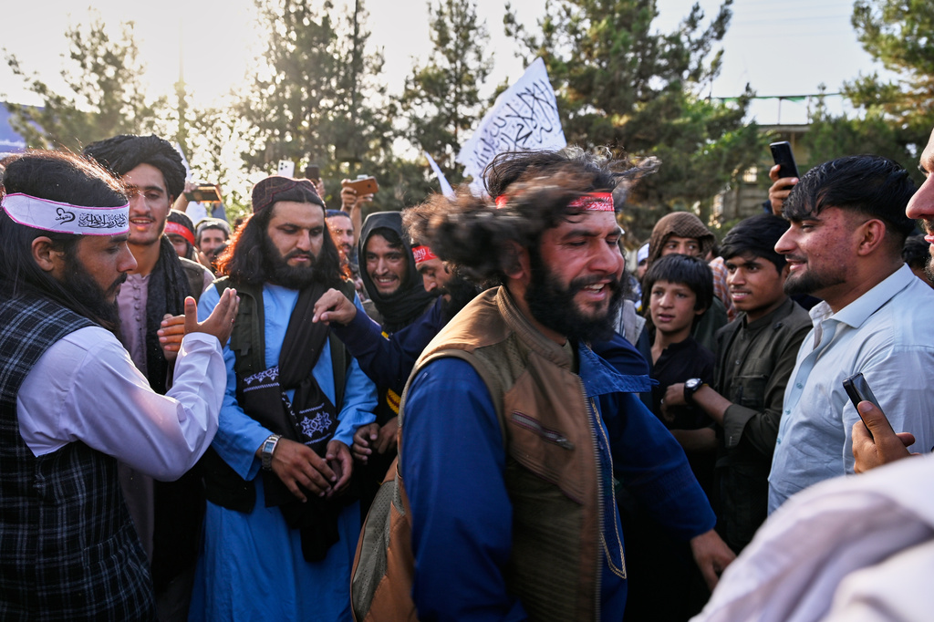 Taliban government supporters dance during celebrations marking the fifth anniversary of the U.S. withdrawal from Afghanistan and the Taliban's return to power, in Kabul, Afghanistan, Saturday, Aug. 15, 2026. (AP Photo/Nava Jamshidi)