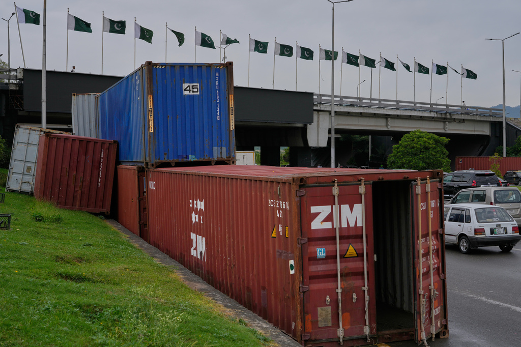 Shipping containers placed by authorities along side on a highway for seal off an area ahead of a plan protest march by the supporters of imprisoned former Prime Minister Imran Khan demanding his release, in Islamabad, Pakistan, Monday, Sept. 28, 2026. (AP Photo/Anjum Naveed)