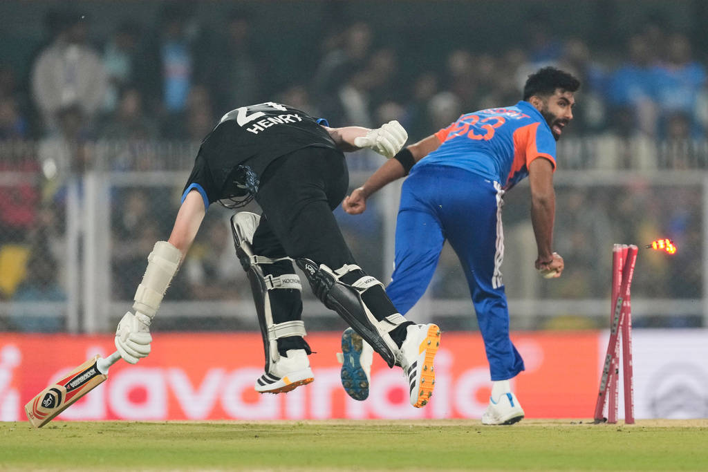 New Zealand's Matt Henry, left, run out by India's Jasprit Bumrah during the third T20 cricket match between India and New Zealand in Guwahati, India, Sunday, Jan. 25, 2026. (AP Photo/Anupam Nath)