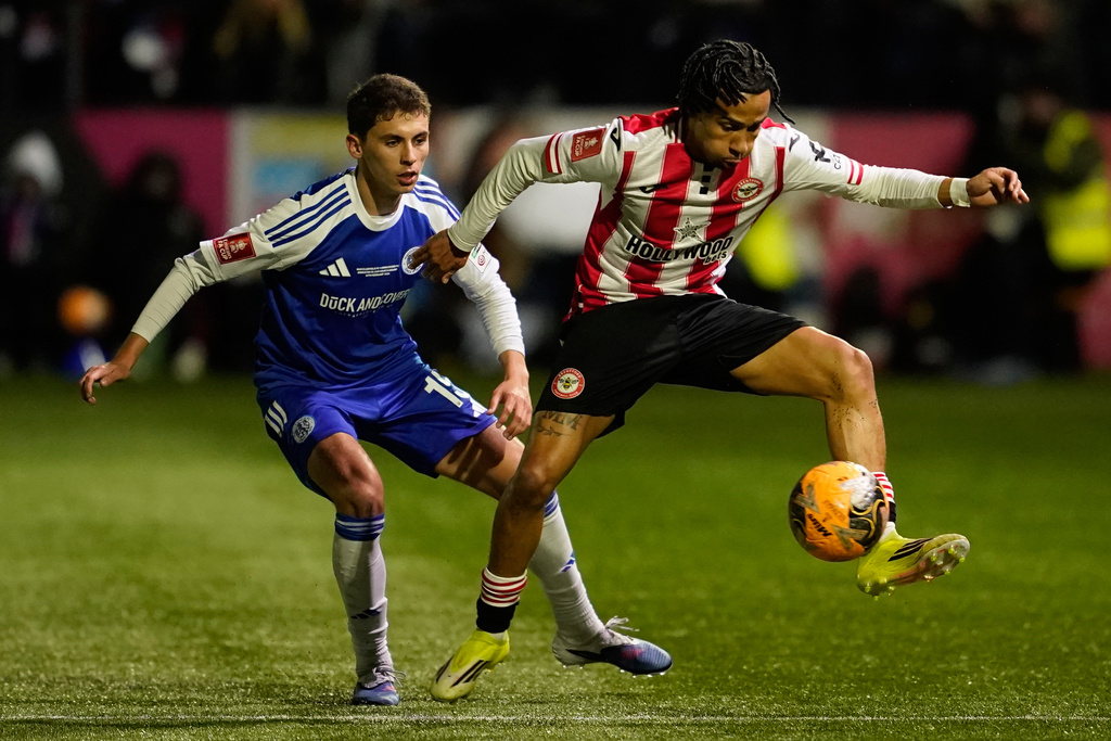 Brentford's Romelle Donovan receives the ball in front of Macclesfield's Luis Lacey during the English FA cup fourth round soccer match between Macclesfield and Brentford in Macclesfield, England, Monday, Feb. 16, 2026. (AP Photo/Dave Thompson)