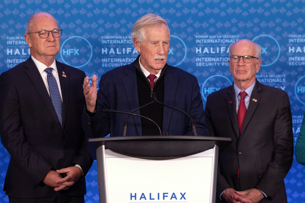 Sen. Angus King, I-Maine, speaks alongside Sen. Kevin Cramer, R-N.D., left, and Sen. Peter Welch, D-Vt., right, during a press conference at the Halifax International Security Forum in Halifax on Saturday, Nov. 22, 2025. (Kelly Clark/The Canadian Press via AP)