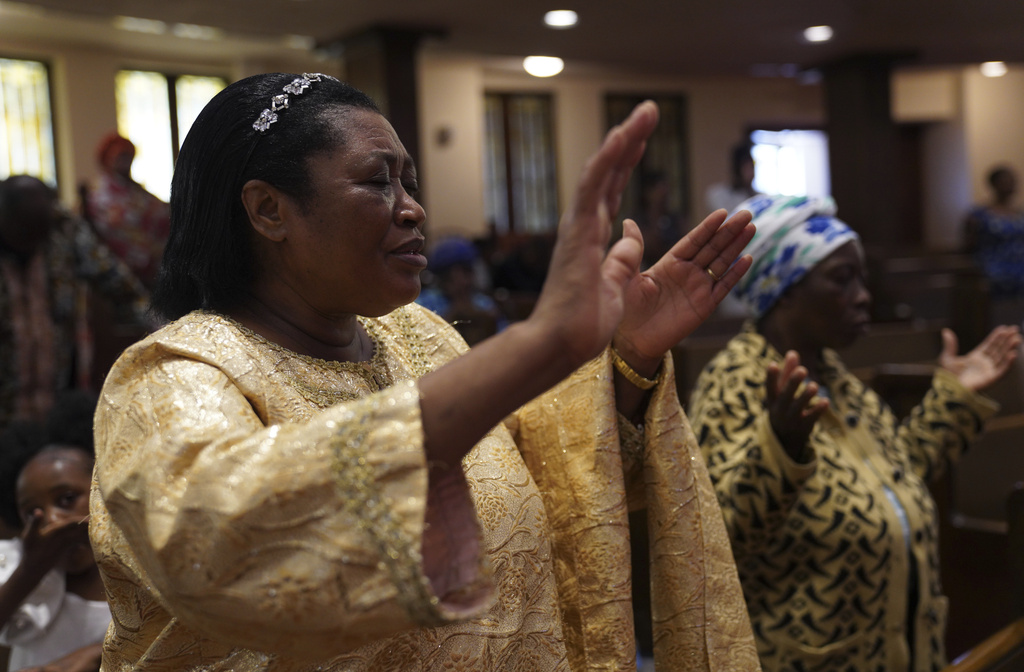 Perpetua Nsabimana, wife of the Rev. Daniel Niyonzima, prays during service at St. Paul's United Methodist Church on Sunday, Aug. 9, 2025, in Cedar Rapids, Iowa. (AP Photo/Jessie Wardarski)