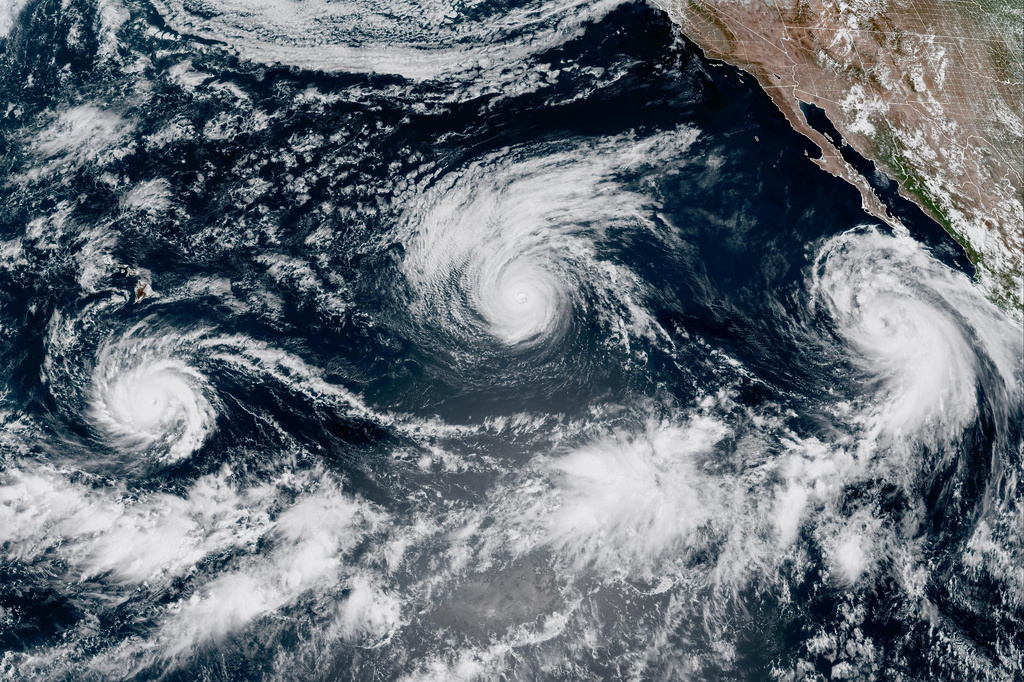 This satellite image provided by CIRA/NOAA shows three storms, from left, Hurricane Lowell, Hurricane Karina and Tropical Storm Marie in the Pacific Ocean on Wednesday, Sept. 2, 2026. (CIRA/NOAA via AP)