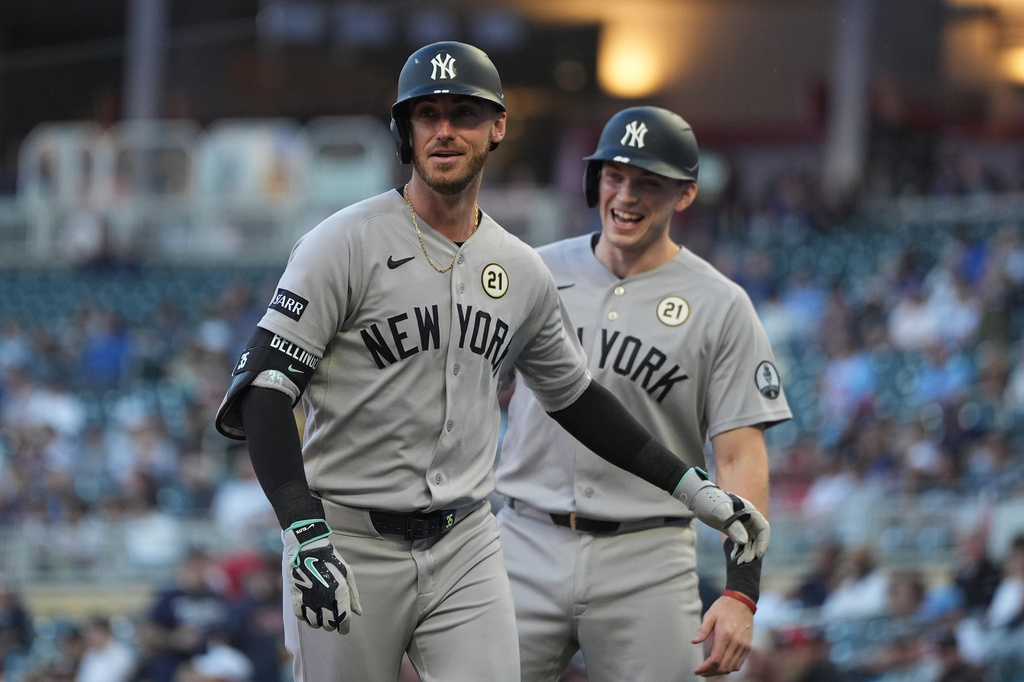 New York Yankees left fielder Cody Bellinger, front, jogs toward the dugout after crossing home plate after hitting a 2-run home run during the first inning of a baseball game against the Minnesota Twins Tuesday, Sept. 15, 2026, in Minneapolis. (AP Photo/Abbie Parr)